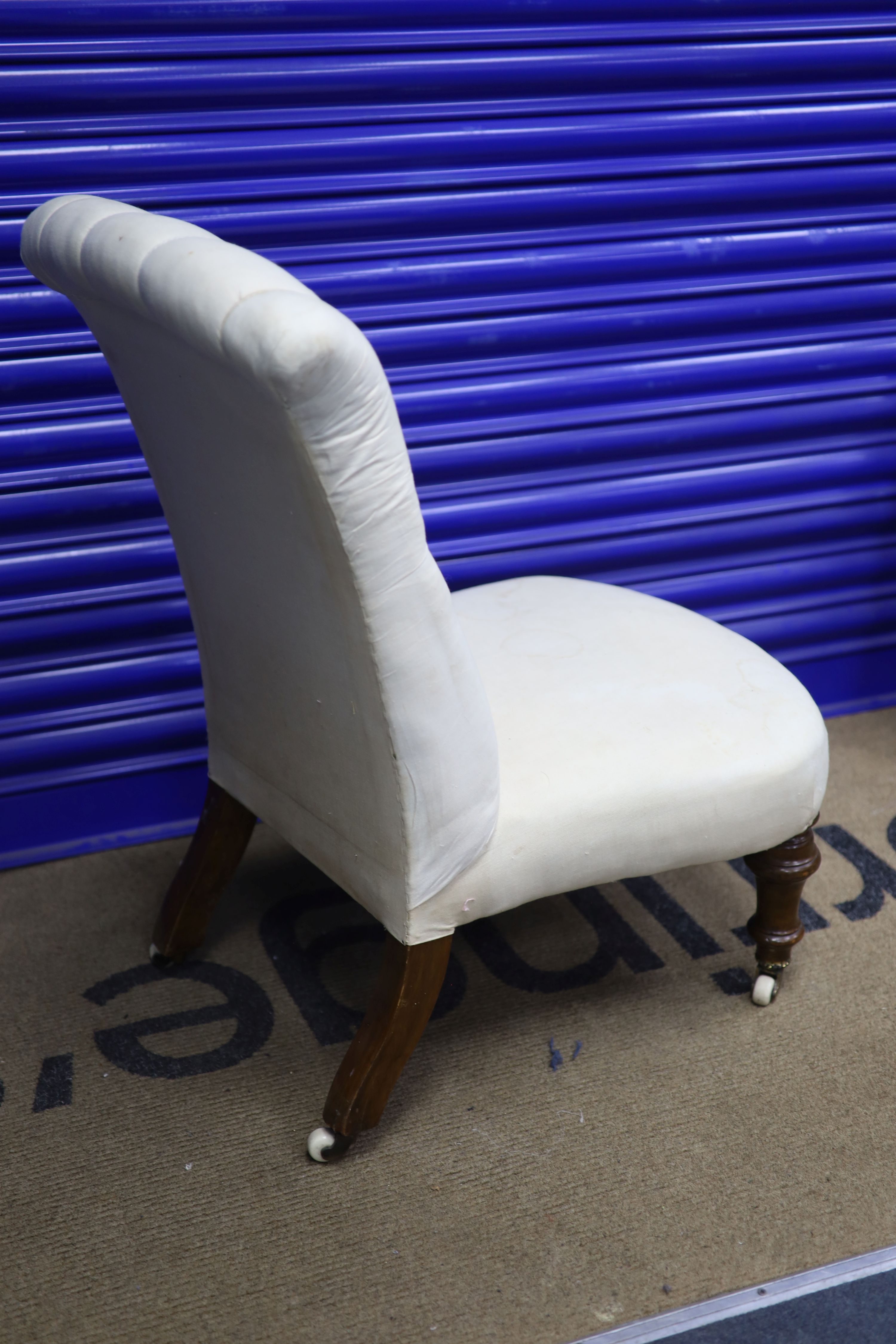 A Victorian walnut framed button back nursing chair, height 79cms width 47cms